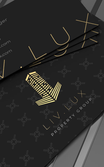 Elegant black business card design for LIVLUX Property Group with gold typography and a building logo.